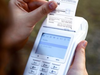 a person holding a cell phone and a receipt